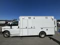 A white 2013 Chevrolet Express van with a boxy design featuring three rooftop lights and multiple side doors
