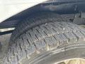 Close-up of two heavily treaded tires of a 2020 Freightliner MT45 showing wear patterns and grooves on the rubber surface