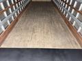 A 2022 International MV607 truck with a wooden floor and metal sidewalls inside the cargo area