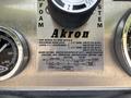A 1999 Freightliner FL80 fire truck control panel with gauges and a metal plate detailing equipment specifications and instructions for hose and nozzle usage