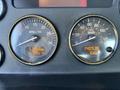 Close-up of the dashboard of a 2020 Peterbilt 330 showing gauges for RPM and speed along with hours of operation and temperature readings