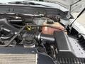 Engine compartment of a 2012 Ford F-450 SD showcasing the air intake system coolant reservoir and battery connections