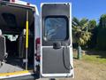 A 2020 RAM ProMaster 3500 with an open rear door revealing the interior space including seats and a partition separating the cargo area