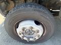 Close-up of a tire and wheel from a 2009 Workhorse W62 showing a silver wheel hub with multiple bolts and a textured tire tread