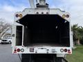 A 2015 Freightliner M2 truck with an open rear compartment featuring two side openings and multiple red and amber lights
