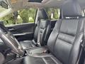 Interior view of a 2014 Honda CR-V featuring black leather seats and a two-tone dashboard with controls