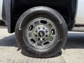 Close-up of a chrome wheel and tire from a 2016 Chevrolet Silverado 2500HD highlighting the Goodyear Wrangler tire tread and Chevrolet logo on the wheel center