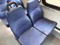 A 2019 Chevrolet Express van with a spacious interior featuring blue fabric seats designed for passenger comfort