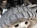 Close-up of a rugged tire with deep treads mounted on a wheel of a 2021 Ford F-350 SD showing its durable design for off-road performance