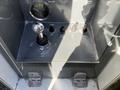 Control panel of a 2011 Freightliner M2 106 featuring various switches and indicators for payload, feed, and lift functions