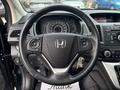 A 2014 Honda CR-V steering wheel with control buttons and the Honda logo visible in the center