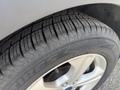 Close-up of a tire from a 2015 Ford Escape showing detailed tread patterns and the alloy wheel design