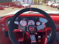 A 1962 Ford 2WHDR interior featuring a sports steering wheel with a Sparco logo and multiple gauges on a red dashboard