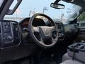 Interior view of a 2017 GMC Sierra 3500HD showcasing the steering wheel dashboard and control panel