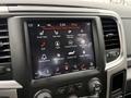 A close-up view of a 2018 RAM 1500 dashboard displaying a touchscreen with various controls and settings including climate and media options