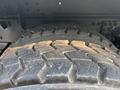 Close-up of the tire tread on a 2016 Freightliner M2 106 showing deep grooves and wear patterns