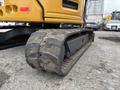 A close-up of the track system on a 2017 John Deere 50G excavator showing its rugged textured surface and metal components