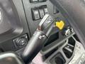 A gear shift lever from a 2025 Peterbilt 536 featuring positions for drive reverse low and neutral with additional controls for lights and other functions