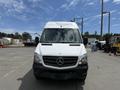 A 2016 Mercedes-Benz Sprinter van with a white exterior and a prominent black grille is parked facing forward with a clear view of its front features