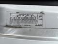 A white 2020 Chevrolet Express van with a detailed manufacturer label showing specifications and information about the vehicle's features and capabilities