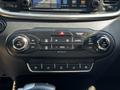 Dashboard controls of a 2017 Kia Sorento featuring climate control buttons and temperature knobs