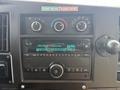 Dashboard of a 2020 Chevrolet Express featuring a radio display with FM station settings and climate control knobs