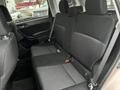 A 2016 Subaru Forester's rear interior seats featuring black fabric and adjustable headrests