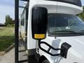 A 2020 Chevrolet Express with a side mirror and door open showing the entrance steps