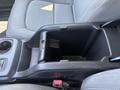 A close-up view of the center console in a 2017 Chevrolet Colorado featuring a storage compartment and cup holder