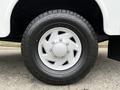 A close-up view of a white wheel rim with five bolts and a black tire with a rugged tread pattern typically found on a 2001 Ford F-350