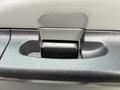Close-up of the door handle of a 2007 Ford F-550 showing a textured black grip and a silver handle mechanism