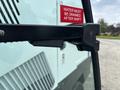 A close-up view of the handle of a 2019 Madvac LS175 with a warning sign reading water must be drained after shift