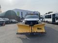 A 2016 RAM 5500 truck with a large yellow snow plow attached to the front