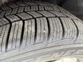 Close-up of a tire tread on a 2014 Ford Escape showing deep grooves and patterns designed for traction