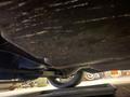 1968 Ford Mustang viewed from underneath showing the undercarriage and a tire with visible wear
