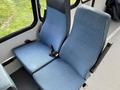 Two blue upholstered seats designed for a 2002 Ford Econoline with visible seatbelts and a modern, clean design.
