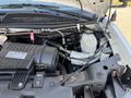 Close-up view of the engine compartment of a 2020 Chevrolet Express showcasing the engine block and various fluid reservoirs