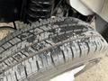 Close-up of a treaded tire on a 2022 Ford E-450 showing detailed patterns and some wear on the rubber surface