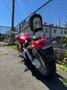 Red 2007 Honda VTX1800F3 motorcycle with a distinctive high back seat and chrome detailing parked on a concrete surface