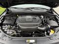 The engine compartment of a 2019 Jeep Grand Cherokee showing a V6 engine with various components and hoses visible