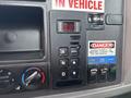 Dashboard controls of a 2020 Peterbilt 330 featuring gear shift levers climate controls and warning lights