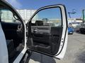 A 2020 Ram 2500 truck's open driver's side door showcasing the interior door panel and handle