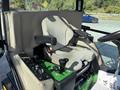 A 2021 John Deere 1575 lawn mower seat with armrests and control levers for operation