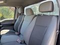 Interior view of a 2019 Ford F-150 with two front seats and a rear bench seat all featuring gray fabric upholstery
