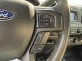 Steering wheel of a 2022 Ford F-550 with controls for volume and phone functions