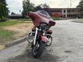 A 2009 Harley-Davidson Road King has a distinctive front fairing and a chrome headlight with a large front tire prominently displayed