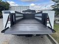 A 2021 RAM 5500 with an open flatbed truck bed featuring foldable sides and a textured surface designed for transporting heavy loads