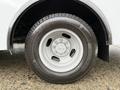 A close-up view of a white tire mounted on a 2019 Chevrolet Express with a steel wheel and six-lug design showcasing a tire tread pattern