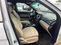 The interior of a 2016 Ford Explorer featuring beige seats and a black dashboard with various controls and a central console