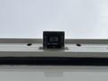 A camera mounted on the roof of a 2012 Ford E-450 Super Duty vehicle with four visible screws and two small red lights on either side